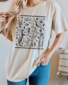 "This eye-catching t-shirt showcases a range of fascinating ocean animals, including a whale, octopus, shark, and turtle.   With its detailed illustrations, this t-shirt is perfect for anyone who loves marine life and the beauty of the ocean. Did you know that the ocean is home to millions of species of marine life, many of which are still undiscovered? From the depths of the ocean floor to the coral reefs and beyond, there's a whole world of marine life waiting to be explored. It's an incredible ecosystem, and one that we should all work to protect and preserve. Whether you're a marine enthusiast, ocean lover, or simply looking for a unique and stylish t-shirt, this design is sure to make a statement and spark conversation. With its soft, comfortable fabric and high-quality printing, it's Cotton T-shirt With Shark Design For Summer, Ocean Floor, Paw Design, Coral Reefs, Sea Creature, Ocean Lover, Ocean Animals, Sea Ocean, Sea And Ocean