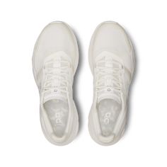 a pair of white sneakers on a white background