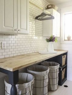 the kitchen is clean and ready to be used as a storage area for trash cans