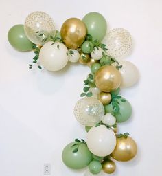 a number seven made out of balloons and greenery