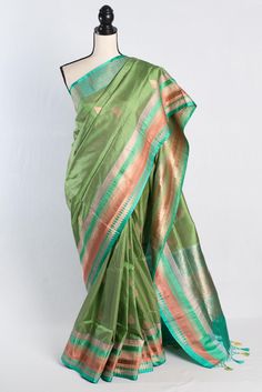 Elevate your ethnic wardrobe with our exquisite Silk Mark Certified Katan Banarasi Saree with a 42 Size Stitched Blouse in vibrant green, featuring a stunning multi-color border. Exclusively curated by Bengal Looms, this saree embodies timeless elegance and superior craftsmanship. Experience the sophistication and comfort of authentic Katan silk, perfect for any special occasion. Enjoy free fast shipping from within the USA, ensuring that this luxurious piece reaches you swiftly. Indulge in the finest with Bengal Looms' exceptional collection of Indian saris, readymade blouses, dupattas, kurtis, and more. Ready Stitched 42 Size Blouse which can be adjusted to size 44. Color : Green and Gold. Blouse Piece : Yes. Fall Pico : Yes.  Care: Dry-Clean Only. Fitted Green Paithani Silk Traditional Wear, Fitted Green Tussar Silk Traditional Wear, Fitted Green Tussar Silk Blouse Piece, Green Cotton Silk Blouse Piece For Traditional Ceremonies, Green Cotton Silk Traditional Wear For Ceremonies, Green Handloom Paithani Silk Blouse Piece, Green Chanderi Blouse For Traditional Ceremonies, Green Paithani Silk Blouse Piece For Eid, Eid Green Paithani Silk Blouse Piece