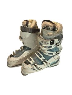 an old pair of snowboard boots sitting on top of each other