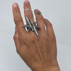 The Glam warrior collection was some of the very first wax carving I designed on my silversmithing journey. Geometric, bold, in a star shape, the perfect mix of Old Hollywood and futuristic sharp lines. This piece is sure to make a statement.Post apocalyptic meets old Hollywood, wear this ring as a shield, and shine bright! The star is app 50 long x 30mm wide The band is about 6mm wide Oxidized to give a beautiful dark colour and then roughly polished to give more character. Please consider that Crystal Jewelry Earrings, Starburst Ring, Goth Ring, Ghost Gifts, Bones Bracelet, Jewelry Gothic, Wax Carving, Jewels Rings, Geometric Star