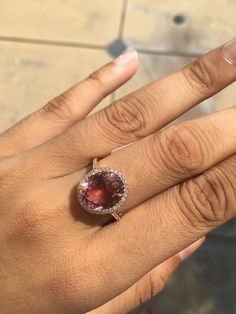 a woman's hand with a ring on it and a stone in the middle