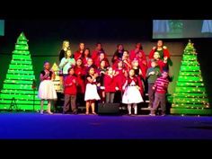 children's choir with christmas trees in the background