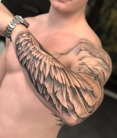 a man is showing off his arm with an eagle tattoo on it