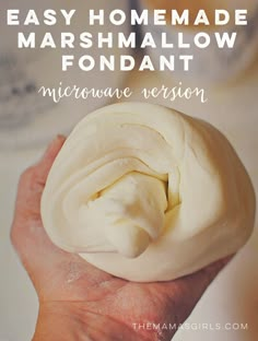 a person holding a doughnut with the words easy homemade marshmallow fondant microwave version