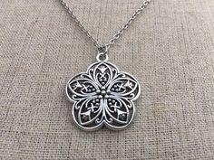 Chic and pretty boho flower pendant necklace. It has incredible detail and is very versatile.  The perfect everyday necklace!  It would also make a sweet little gift.The pendant measures 1 1/8” long by 1” wide and hangs from a simple stainless steel necklace chain with a lobster clasp.I have matching earrings in my shop, if you would like the whole set.  Here is the link........... https://etsy.me/35eCXaU Thanks for stopping by!  Please take a moment and visit the rest of my Etsy shop.  I have m Bohemian Flower Shaped Jewelry As A Gift, Bohemian Flower Charm Pendant Necklace, Bohemian Flower Pendant Necklace As Gift, Bohemian Jewelry Pendant With Flower Charm, Bohemian Necklace With Flower Pendant, Bohemian Necklace With Flower Pendant As Gift, Bohemian Pendant Jewelry With Flower Charm, Silver Bohemian Flower Pendant Jewelry, Adjustable Silver Bohemian Flower Necklace