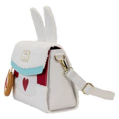 In a rush? Arrive fashionably late! Make the Loungefly Disney Alice in Wonderland White Rabbit Cosplay Crossbody Bag a timely addition to your wardrobe. This charming bag is covered in soft white sherpa fabric in honor of Disney’s White Rabbit. His applique ears stick up over the top, and on the flap, you’ll find applique scalloped blue trim from his outfit. Below the flap, you’ll see the Red Queen’s signature heart, which the White Rabbit wears as part of his costume, and on either side, fields Disney White Travel Shoulder Bag, Disney Style White Shoulder Travel Bag, White Rabbit Cosplay, Fun Purses, Rabbit Cosplay, Alice In Wonderland White Rabbit, Wonderland White Rabbit, Alice In Wonderland 1951, Disney Alice In Wonderland