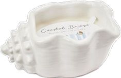 a white ceramic bowl with pearls on the rim and label that says confection bridge