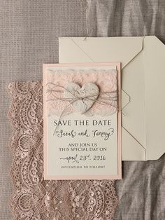 a wedding save the date card and envelope with lace on it next to an envelope