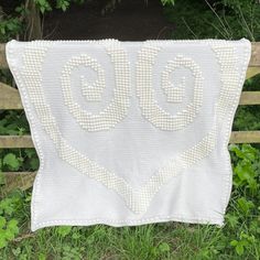 a white crocheted blanket with the word go written on it in cursive letters