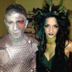 two people dressed in costumes standing next to each other with green hair and makeup on