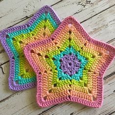 two crocheted coasters sitting on top of a wooden table