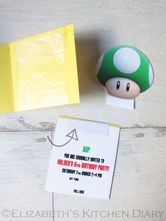 an image of a mushroom birthday party with information card and candy wrapper on the table