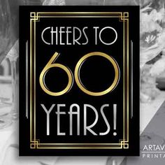 a black and gold sign that says cheers to 60 years