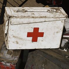 an old medical box with a red cross on it