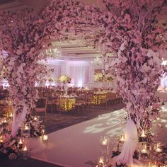 an indoor wedding venue decorated with flowers and candles