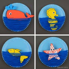 four plates with different pictures of fish and starfish on them, all in blue