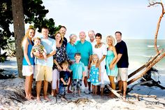 a group of people standing next to each other on a beach