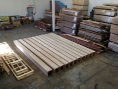 several stacks of wooden boards in a warehouse