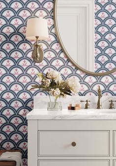 a bathroom vanity with a mirror and flowers on it