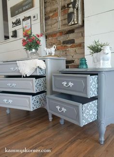 two dressers with drawers painted in gray and white, one has flowers on top