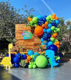 an outdoor party with balloons and decorations