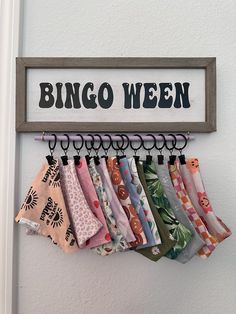 there is a sign that says bingo ween hanging on the wall next to some cloths