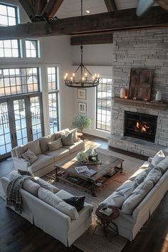 a living room filled with furniture and a fire place in the middle of a room