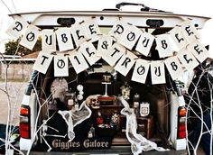 the back end of a van decorated with halloween decorations