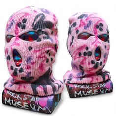 two pink and black skull masks on top of each other