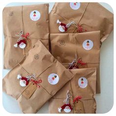 brown wrapping paper wrapped in brown paper with red and white christmas decorations on them, tied together by twine string