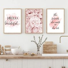 three framed art prints on the wall above a kitchen counter