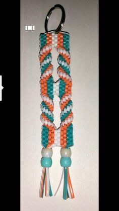 an orange, white and blue beaded key chain