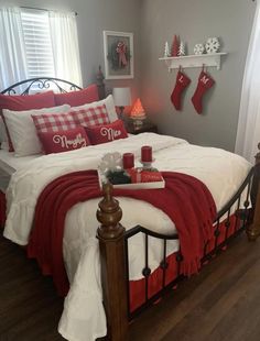 a bedroom decorated for christmas with red and white decor