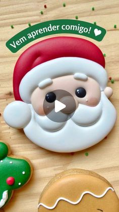 an animated santa clause next to cookies and gingerbreads on a wooden table with the caption'vem appender comigoo '