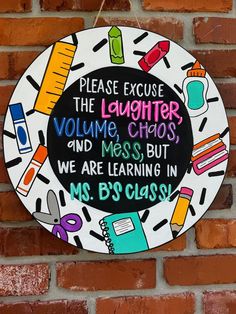 a sign on the side of a brick wall that says, please excuse the laughter chaos and mess but we are learning ms b's class