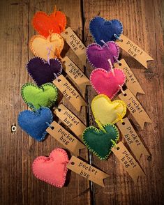 several small hearts are sitting on clothes pins with tags attached to them that say price per piece