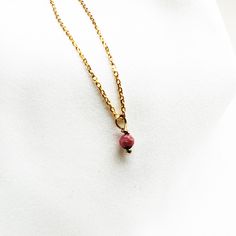 "This  necklace features tiny  Ruby bead. Minimalistic design ,  stylish for every occasion and everyday wear. Perfect looking , unique personal necklace wrapped for gift giving or as a wonderful present for you!  You can choose diffrent gemstones from drop down menu... ♡ DETAILS  Bead gemstone- 4 mm- 0.15\" Necklace length please choose... Material: gold plated 24 k over sterling silver 925 All gemstones are natural, they may vary slightly in color and size.  The jewelry is made entirely of 925 Pink Minimalist Necklace With Delicate Chain, Minimalist Pink Gold Necklace For Gift, Minimalist Pink Pendant Necklace, Pink Minimalist Birthstone Necklace, Dainty Charm Necklaces With Tiny Beads For Gift, Minimalist Pink Necklace For Everyday, Red Minimalist Birthstone Necklace, Minimalist Pink Everyday Necklace, Minimalist Charm Necklaces With Tiny Beads For Gifts