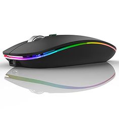 a computer mouse with multi - colored lights on it's side and its reflection in the ground