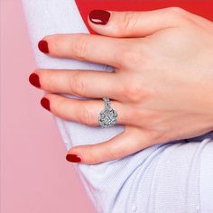 a woman's hand with a diamond ring on it