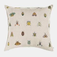 a white pillow with lots of bugs on it