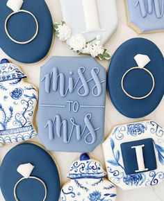 cookies decorated with royal blue icing and the words miss to mrs on them