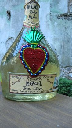 a bottle of alcohol sitting on top of a wooden table