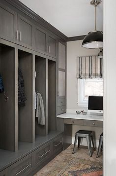 a room that has some drawers and a desk in it with a laptop on the table