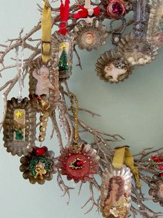 a wreath with ornaments hanging from it's sides