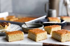 several pieces of cake sitting on top of a white paper towel next to a pan