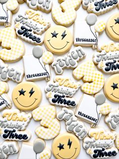 some cookies that are sitting on top of each other with words and smiley faces painted on them