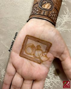 a woman's hand with henna tattoos on it